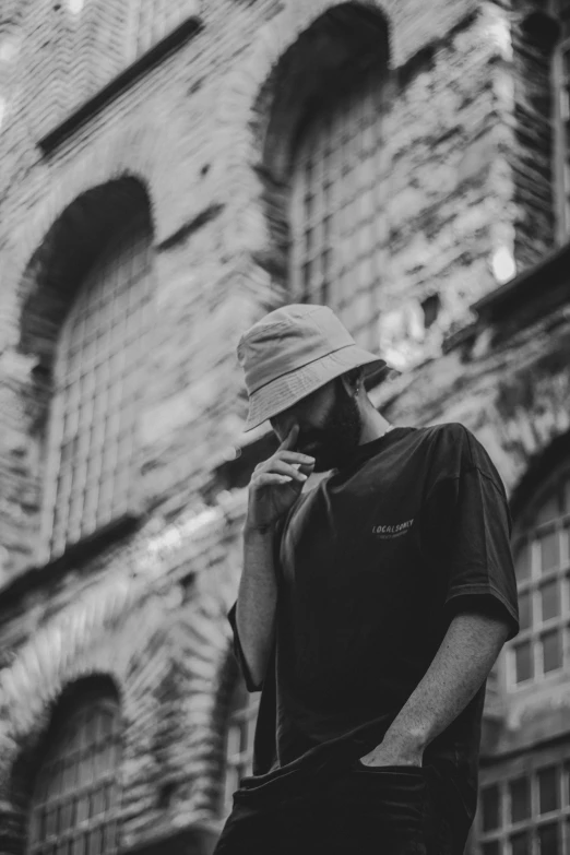 a person smoking next to a brick building