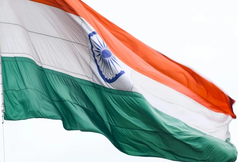 an indian flag flies in the wind with no one around