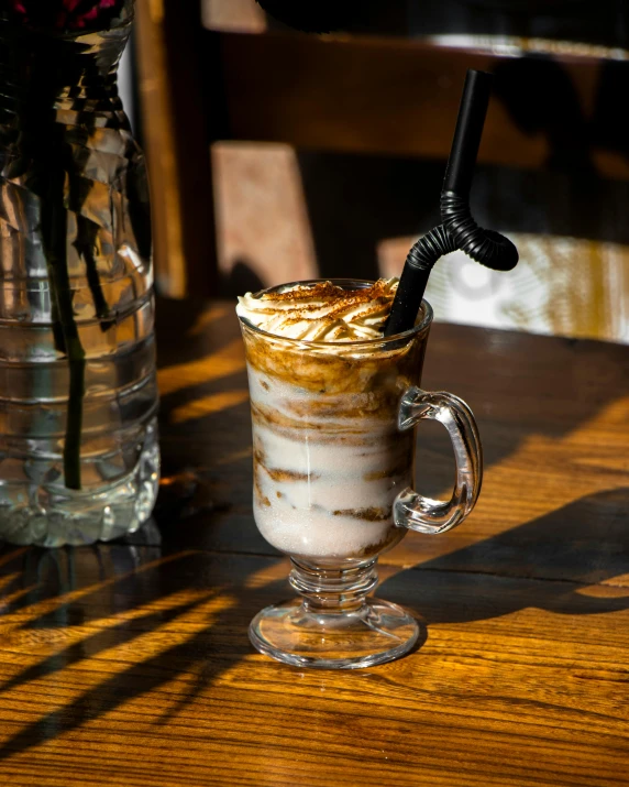 a cup on a table with some kind of liquid