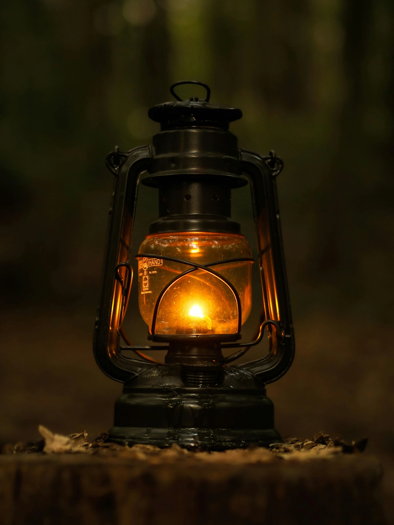 a lantern is glowing in the dark outside