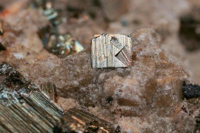 a metal object in the dirt with rocks behind it