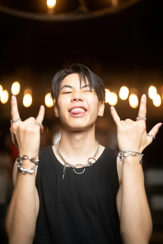 young man posing with both hands in the air