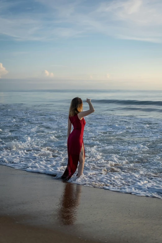 a  in red walking on the beach