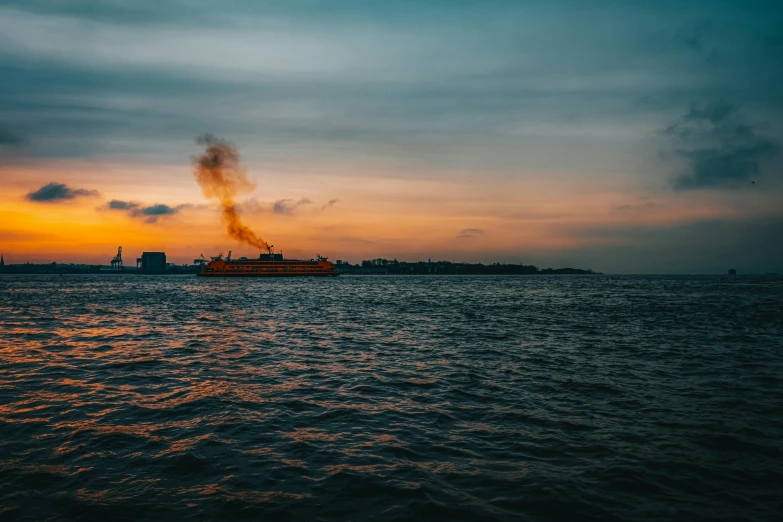 a boat on the water with a smokestack coming out of it