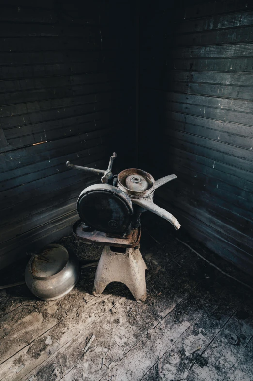 an old stove in a dark room with a wooden background