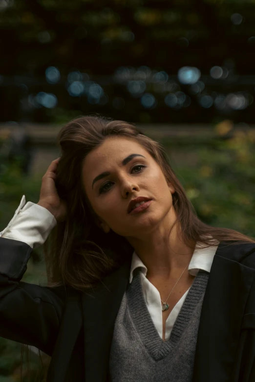 an attractive woman posing for the camera in a garden