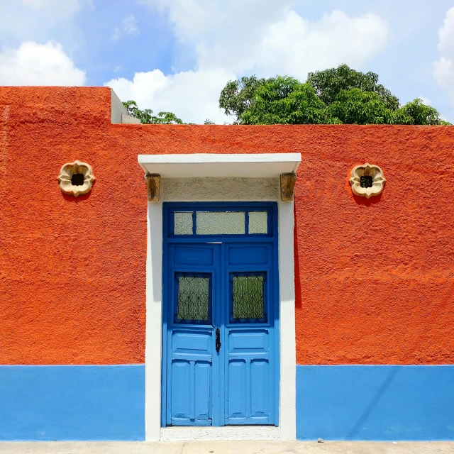 blue and white door and trim with blue sky and clouds