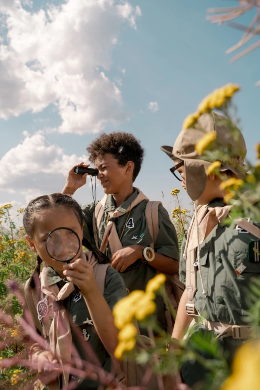 people looking at flowers through a magnifying glass