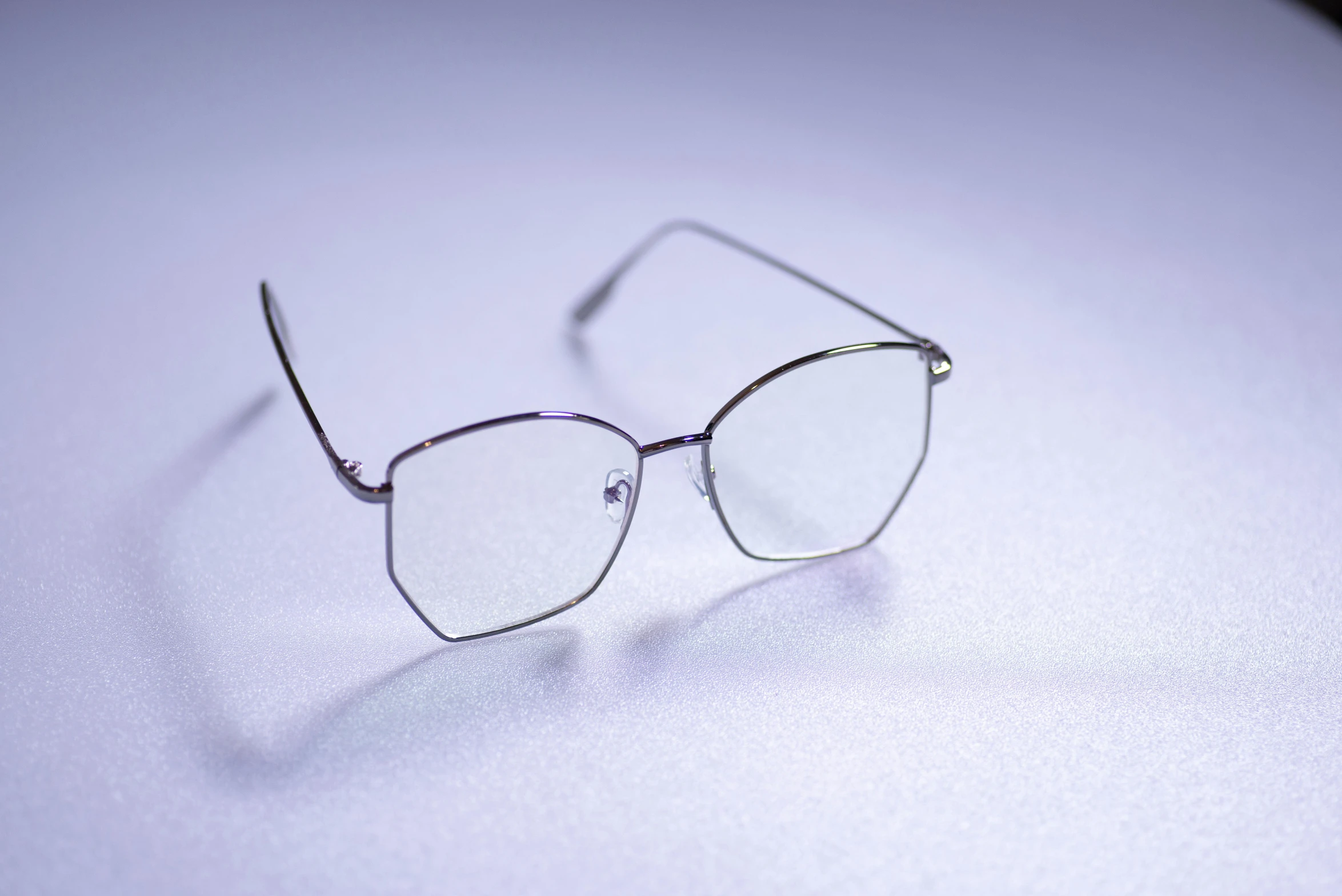 a pair of glasses on a white table