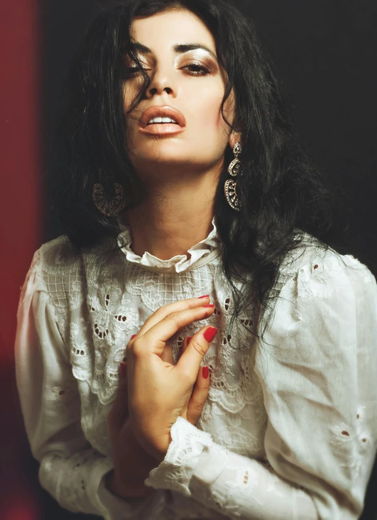 a woman in a white blouse looking up into the distance