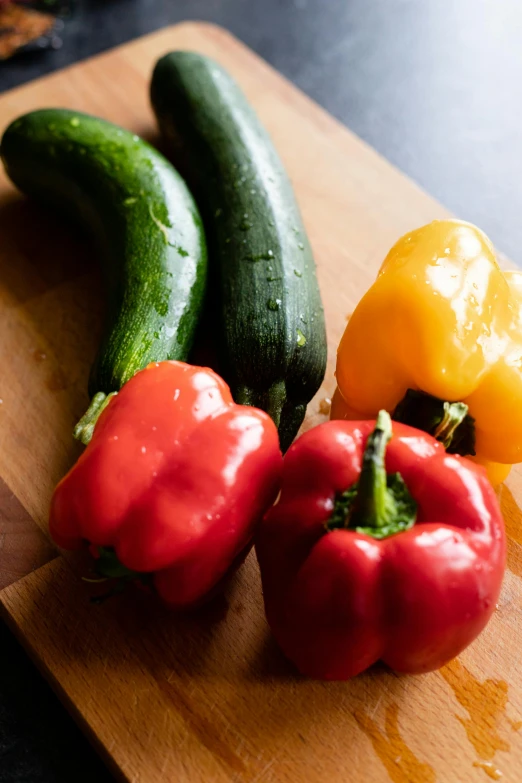 there are two peppers, two yellow and one red pepper