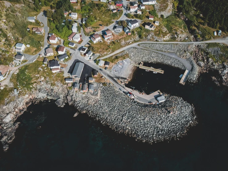 an aerial view of a boat dock and houses along a coast