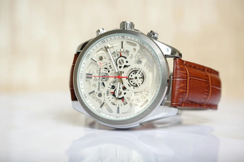 a watch that has white dial and brown leather strap