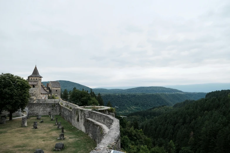 a view from a mountain top of a stone castle