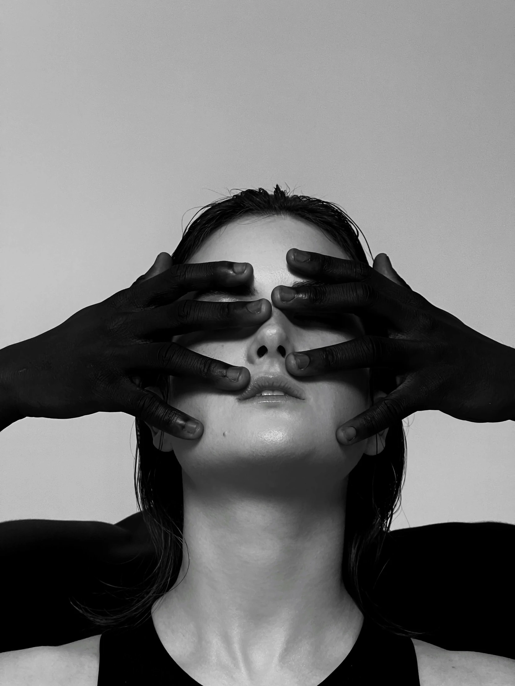 a woman is covering her eyes with hands