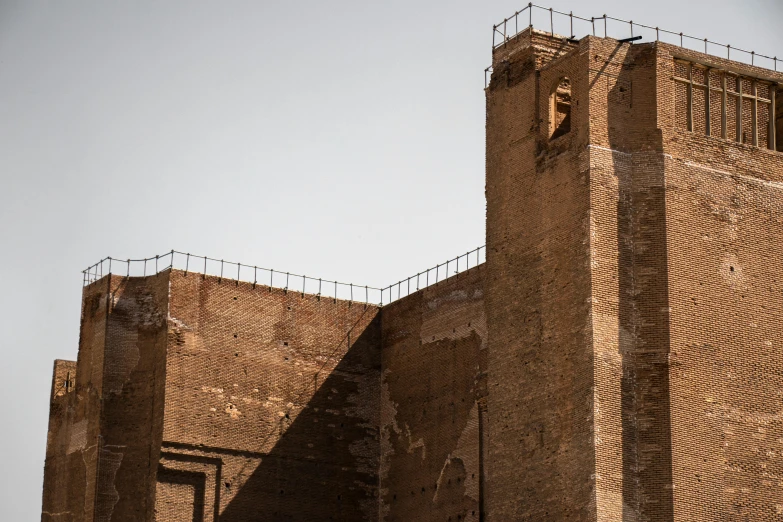 the side view of a brick building that is next to a parking lot