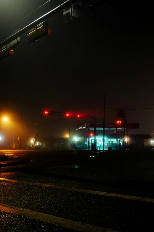 a city street at night with traffic lights