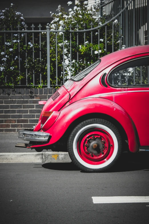 a red beetle parked on the side of a road