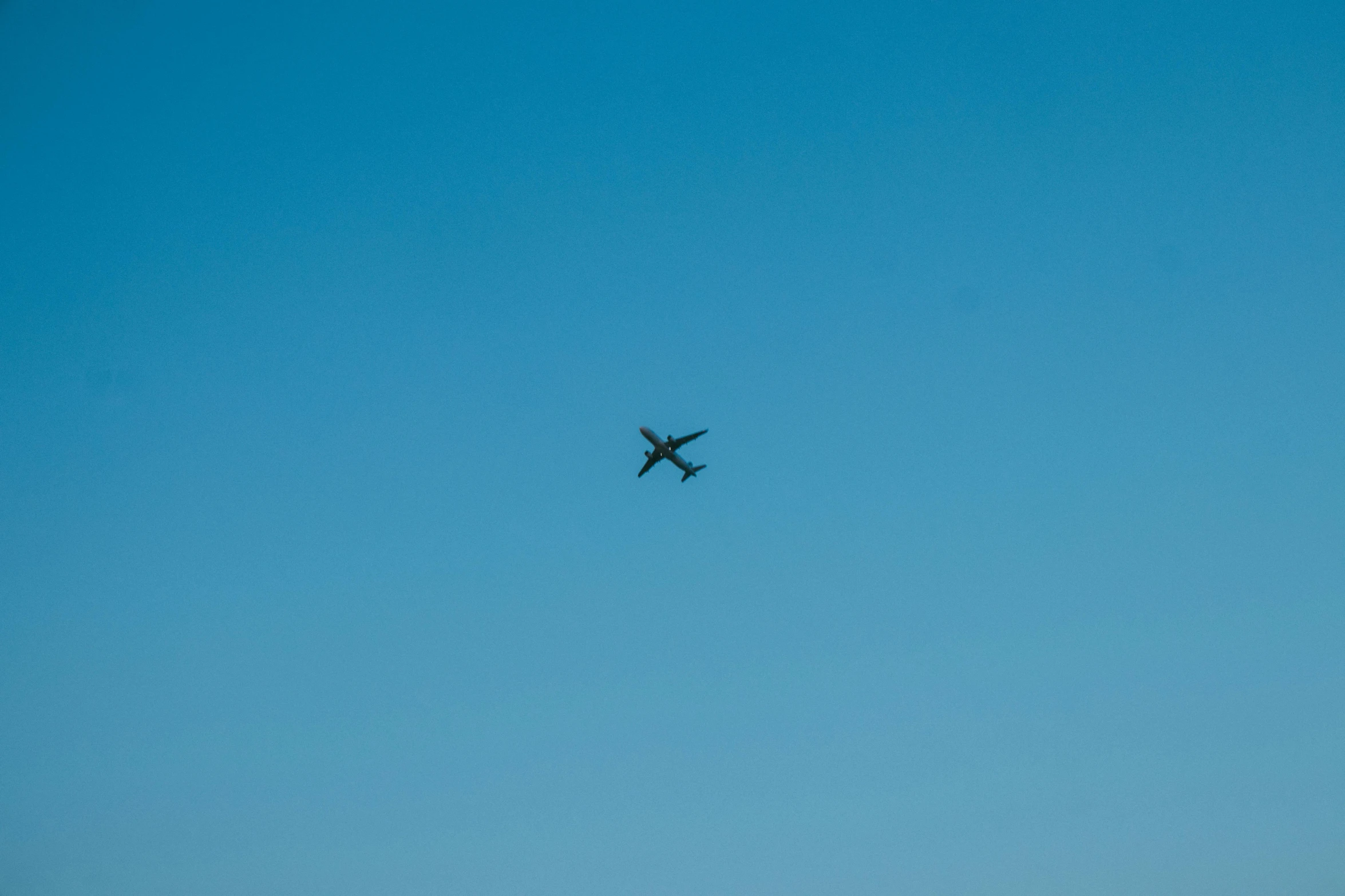 an airplane is flying through a blue sky