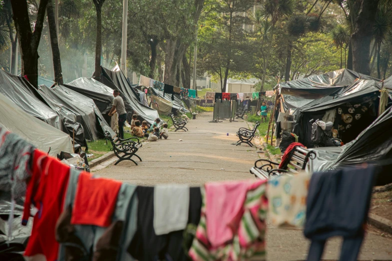 there is a lot of tents with clothes hanging out to dry