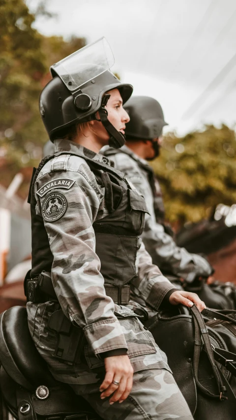 two soldiers are riding horses in the street