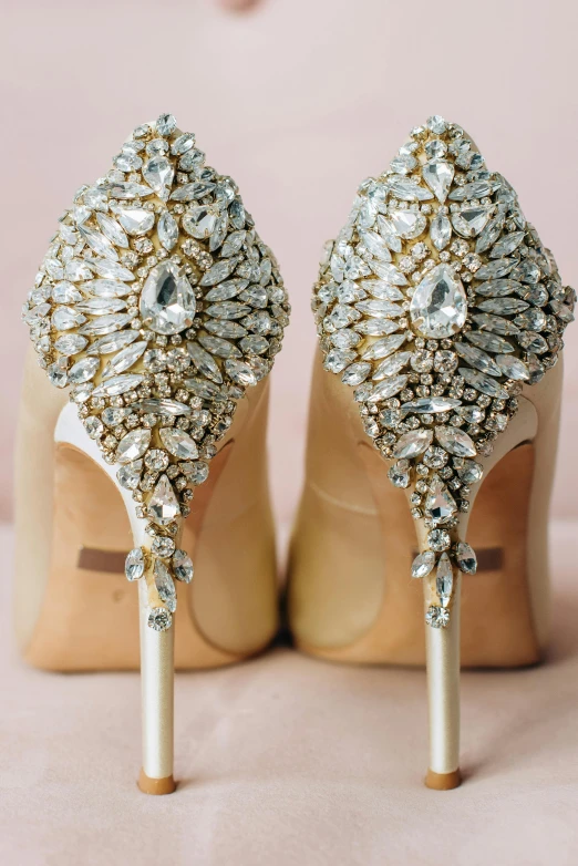 a pair of wedding shoes that are wearing high heel shoes with diamond accents