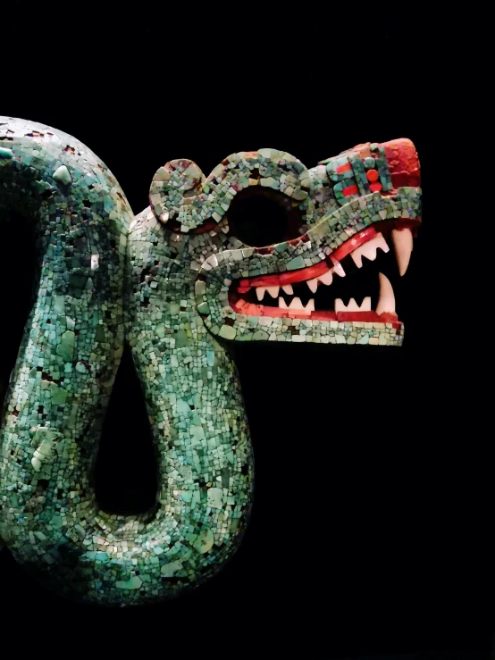 an elaborate sculpture of a green dragon with its mouth open