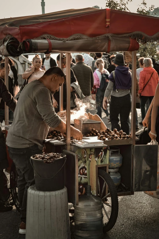 a man that is at a stand cooking soing