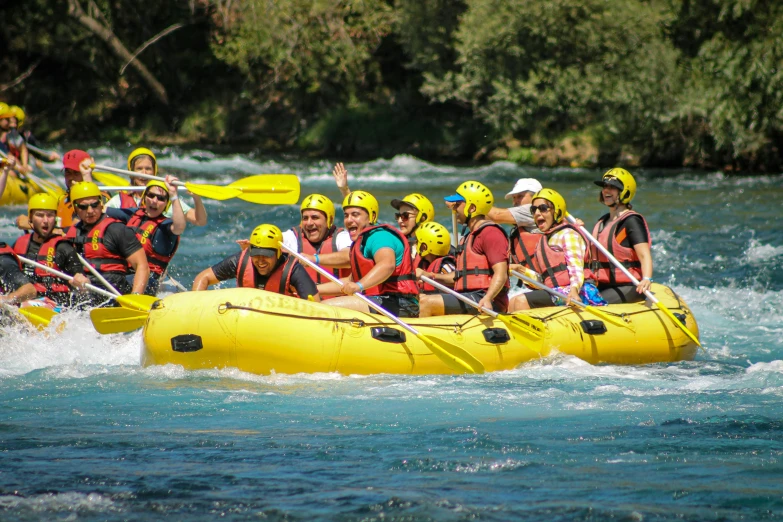 a group of people on rafts paddling in the water