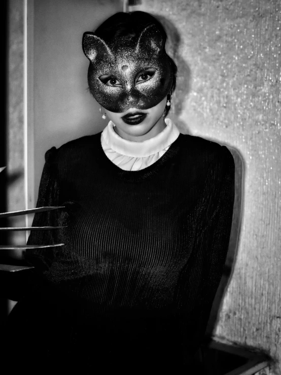 a woman wearing a mask while posing for the camera