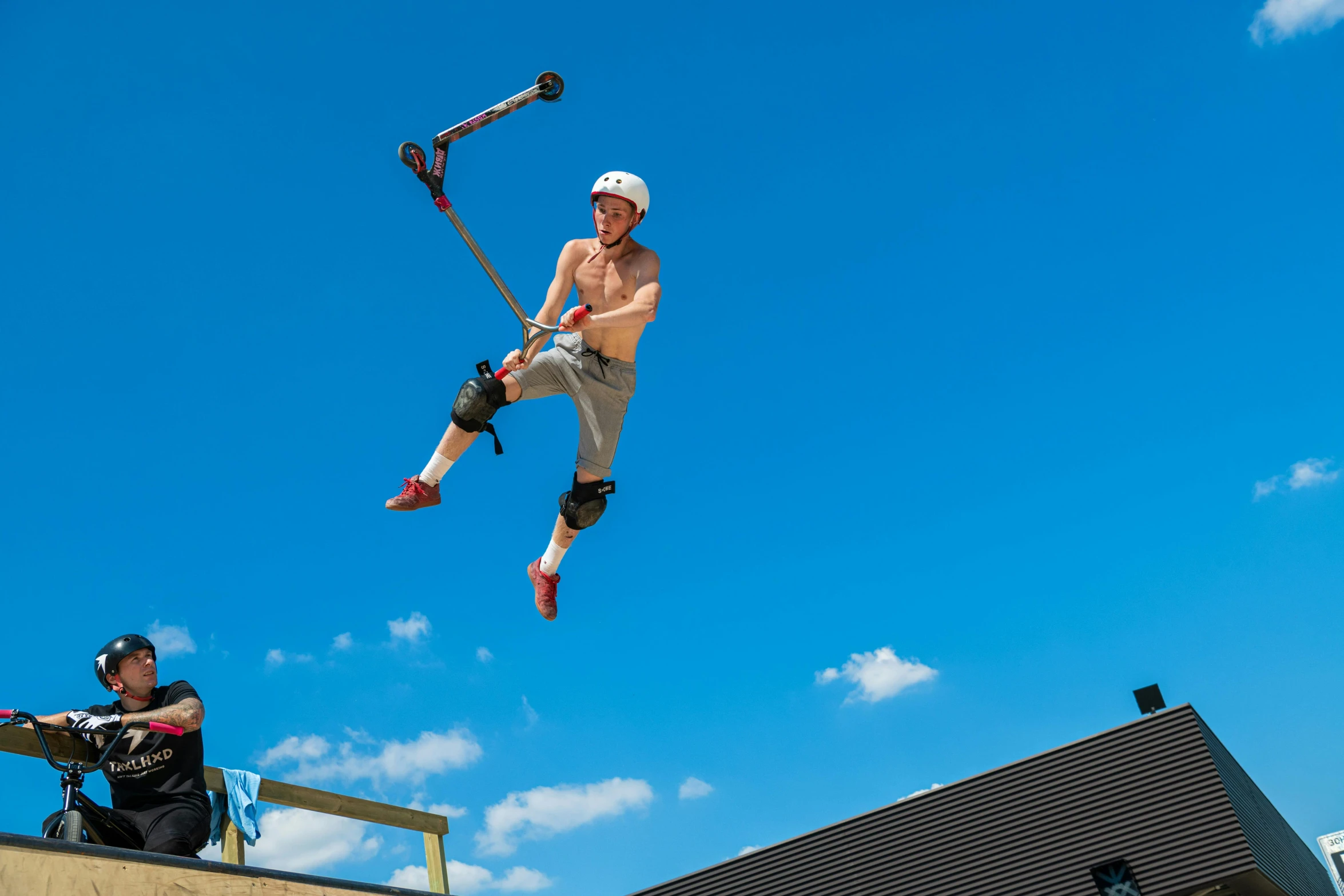 a man is doing tricks with skis on a ramp