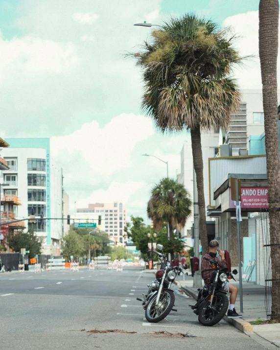 two motorcycles sitting next to each other in the street