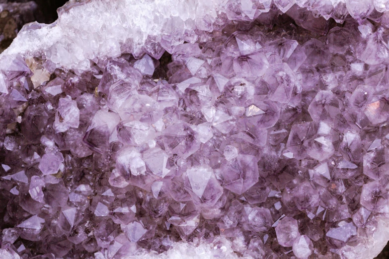 a close up of purple rock, containing chunks of quartz