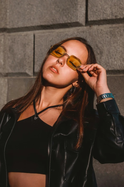 a beautiful young woman in glasses looking at the camera