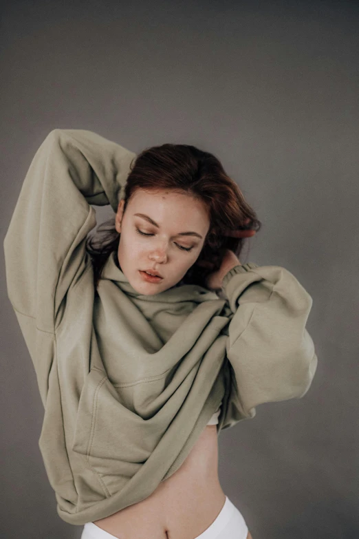 a woman in a white underwear has her arms stretched out