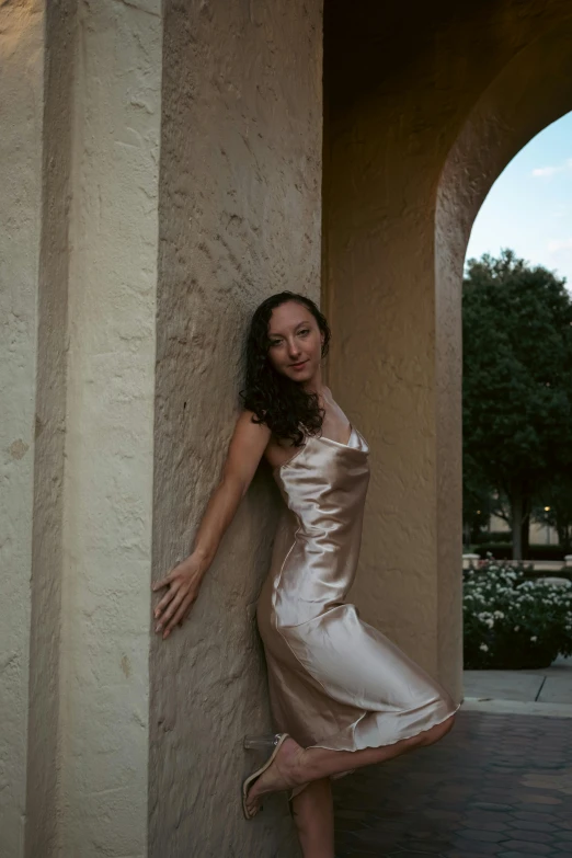 a woman standing on a wall smiling for the camera