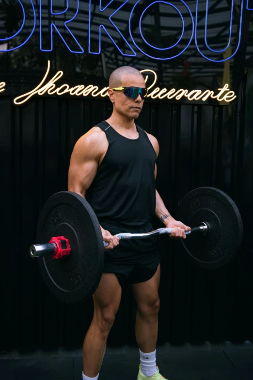 a man in black shirt lifting a barbell