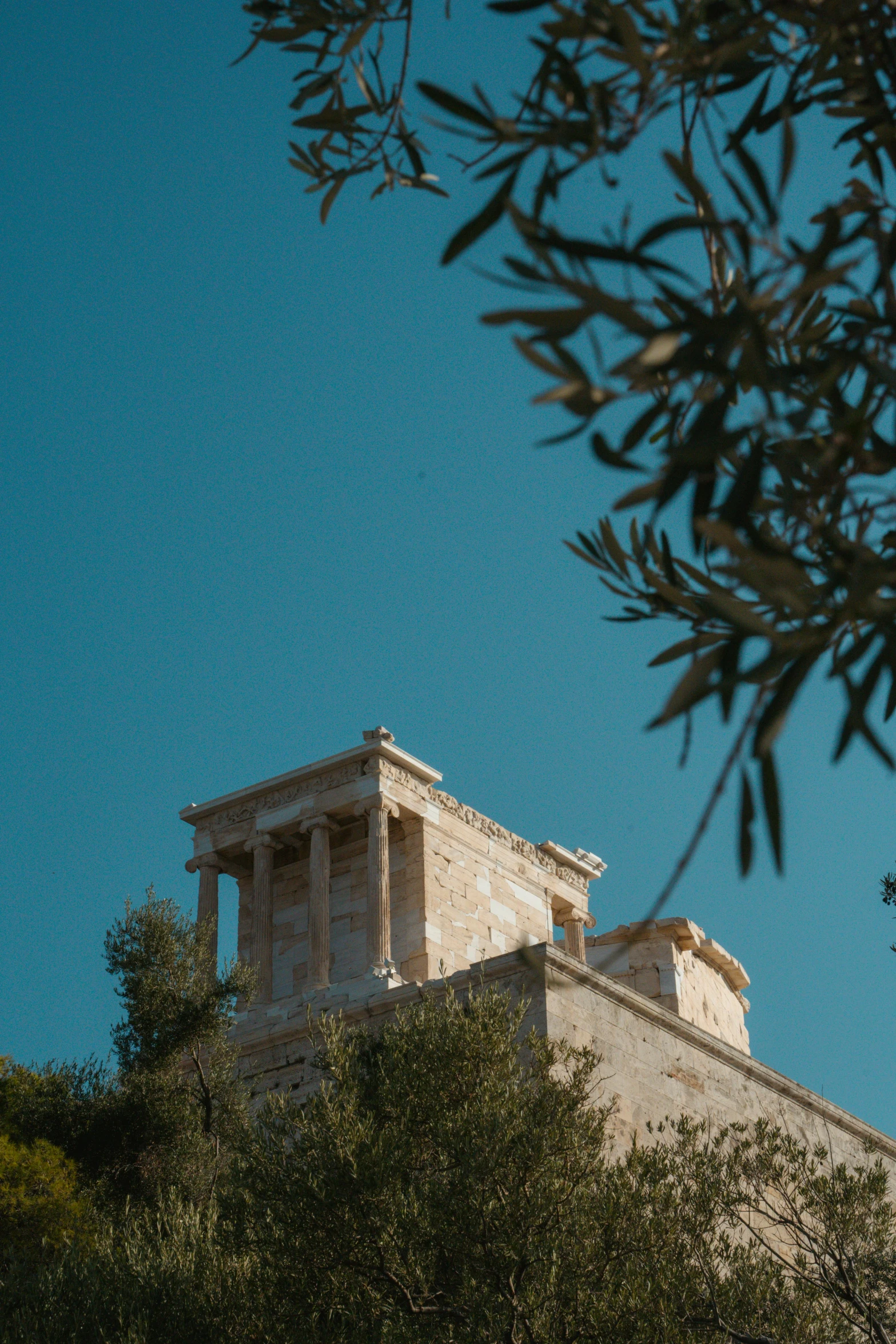 a stone building surrounded by lots of trees