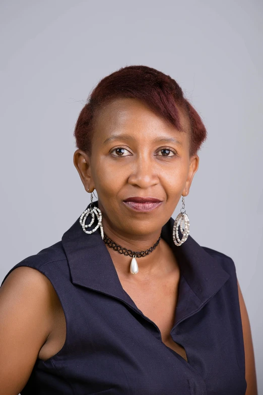 a woman with short red hair smiling at the camera