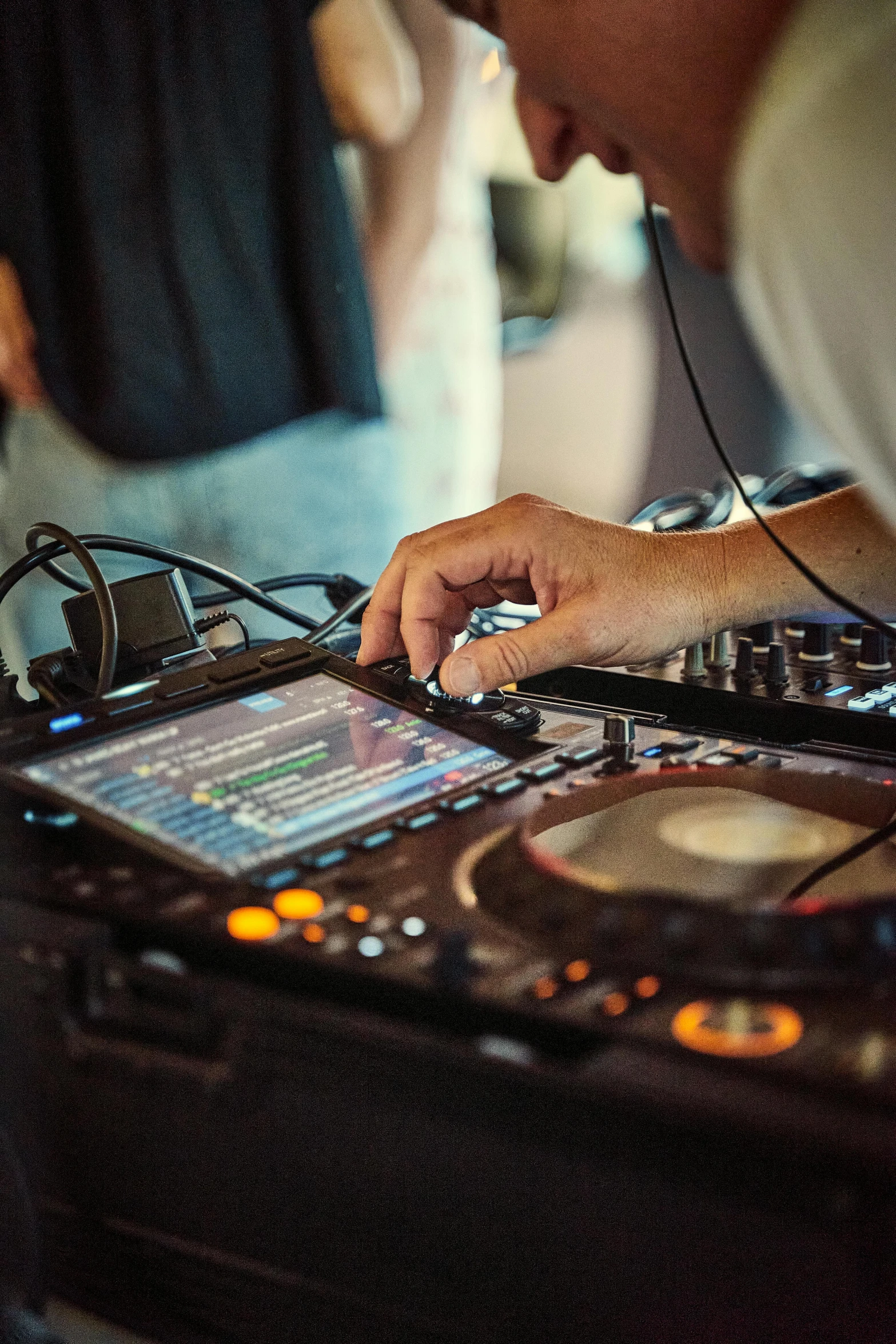a man working on the equipment at a dj mixing