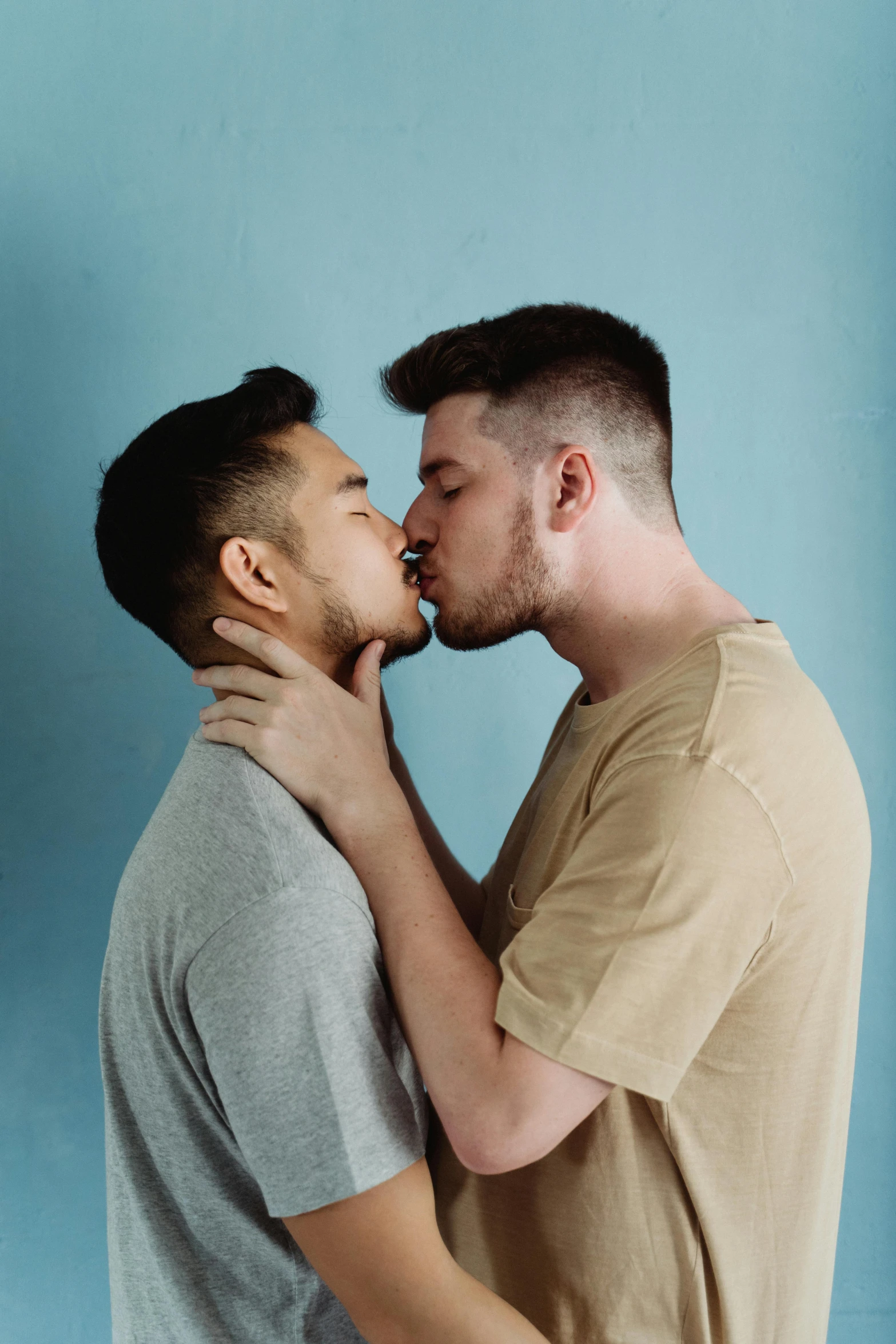 a man holding a woman up against him with his nose