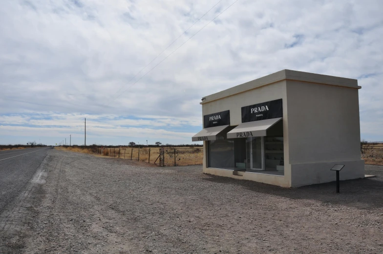 there is a small building next to a street