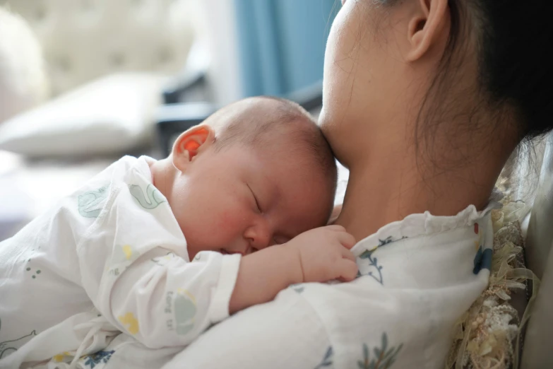 a woman holding her baby close to the camera