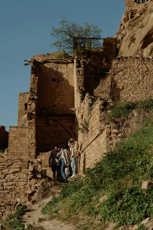 a group of people are climbing up a steep incline