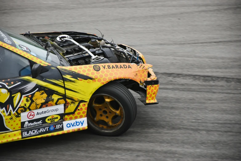 the front end of a yellow and black race car