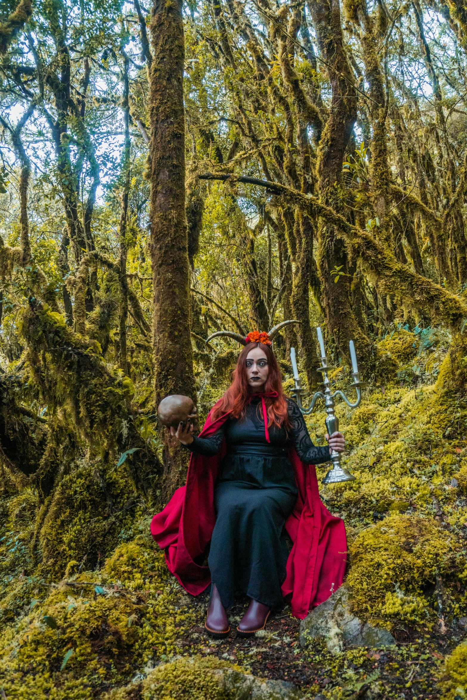 the woman is dressed in an elaborate dress and carrying a sword through the woods