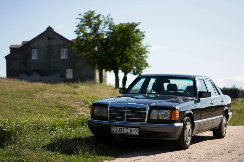 a black car parked on a gravel road