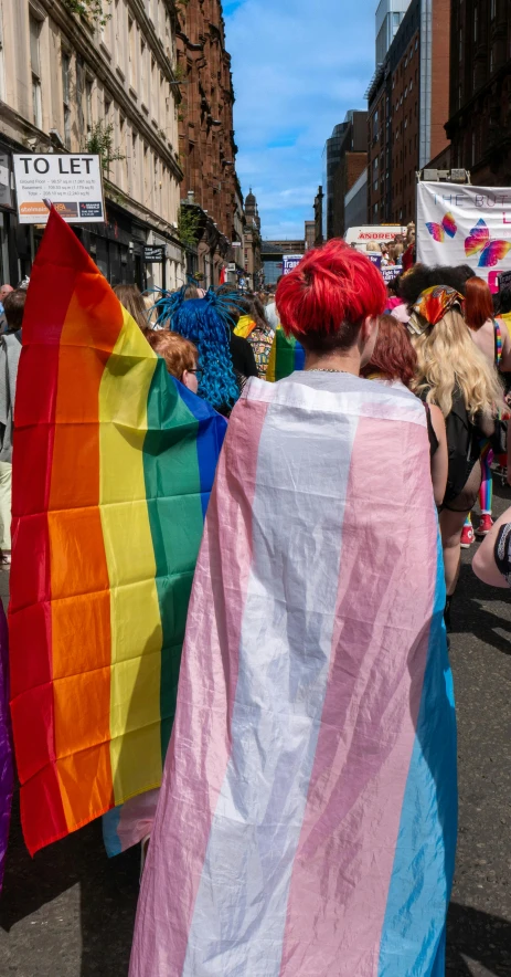 people walking down a street in colorful clothes