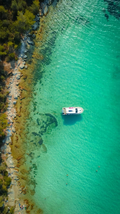 a boat sitting on top of a blue body of water