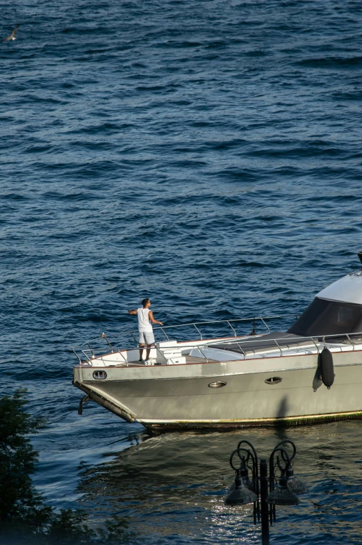 a man is on the back of a boat in the ocean